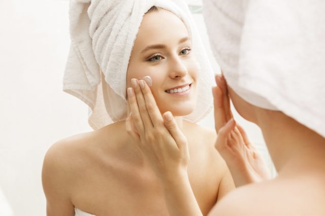 Woman Applying Beauty Product to her Face